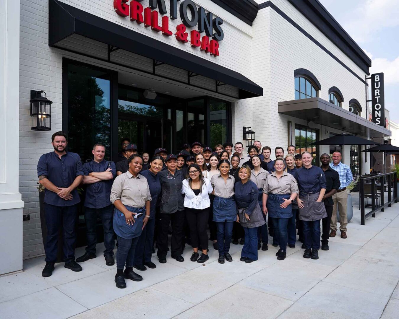 Group photo of the staff in front of Burtons Bar & Grill